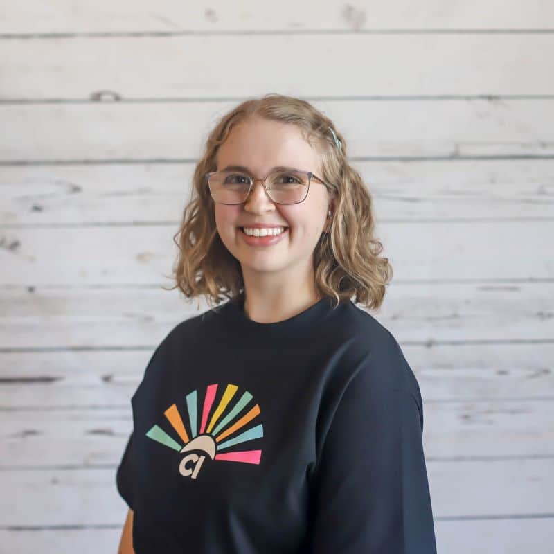 Karina Mrosko, CI Therapies team member, smiling in a professional headshot wearing a black CI Therapies T-shirt.